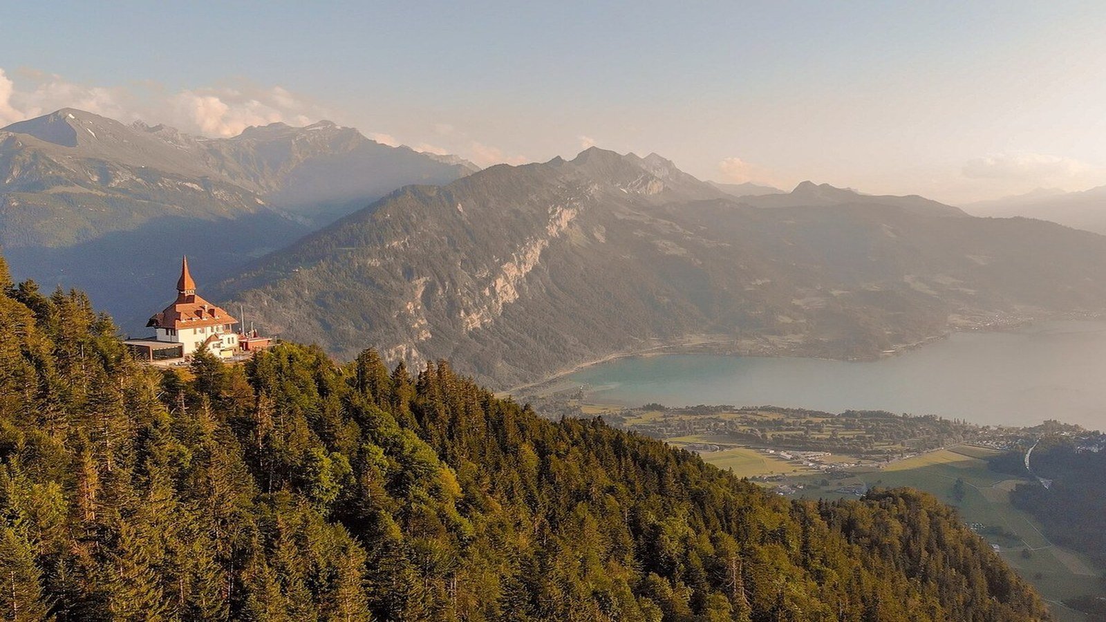 Panoramic view from Harder Kulm summit over Interlaken, Lake Thun and Lake Brienz with Eiger, Moench and Jungfrau peaks