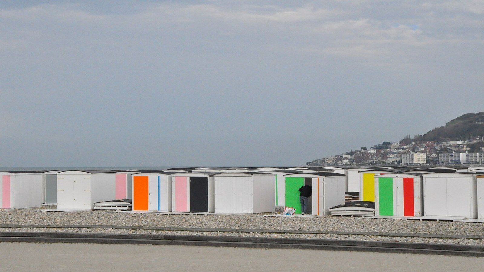 Le Havre beach promenade with colorful seaside cabins summer